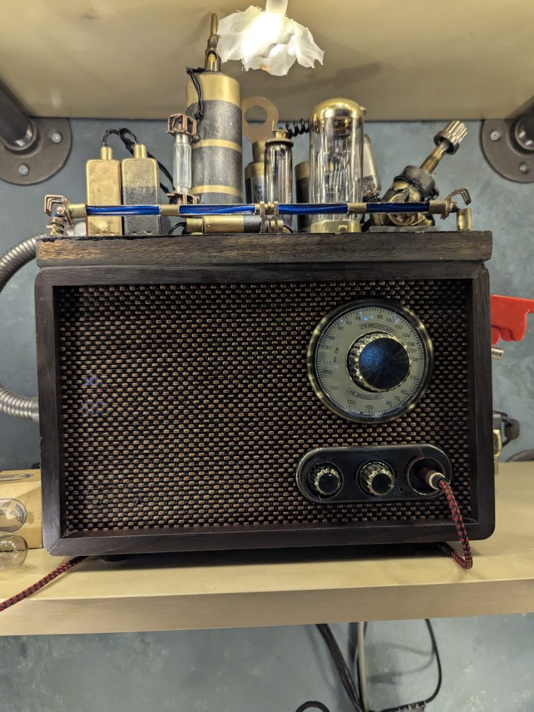 A close up of my writing computer, which is covered in fake, retro-futuristic-style electronic elements